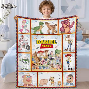 May include: A colorful blanket featuring characters from the "Toy Story" movie, including Woody, Buzz Lightyear, and others. The blanket has a personalized "Daniel Story" design. The border is red and blue, with a white background.