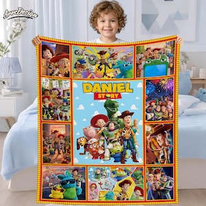 May include: A personalized blanket featuring characters from the animated film "Toy Story." The blanket has a blue background with the name "DANIEL" and the word "STORY" in yellow. The blanket is bordered in red and yellow.