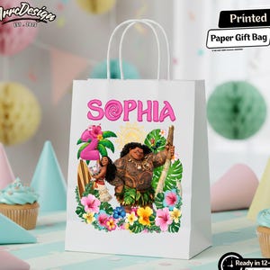May include: White paper gift bag with the name "Sophia" in pink, featuring a colorful illustration of characters from a popular animated movie. The bag has white handles and the text "Printed Paper Gift Bag".