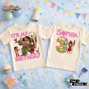 May include: Two cream-colored t-shirts with colorful graphics. One shirt says "IT'S MY BIRTHDAY" with a cartoon image. The other shirt says "Sophia 3" with a floral design. Both shirts are short-sleeved.