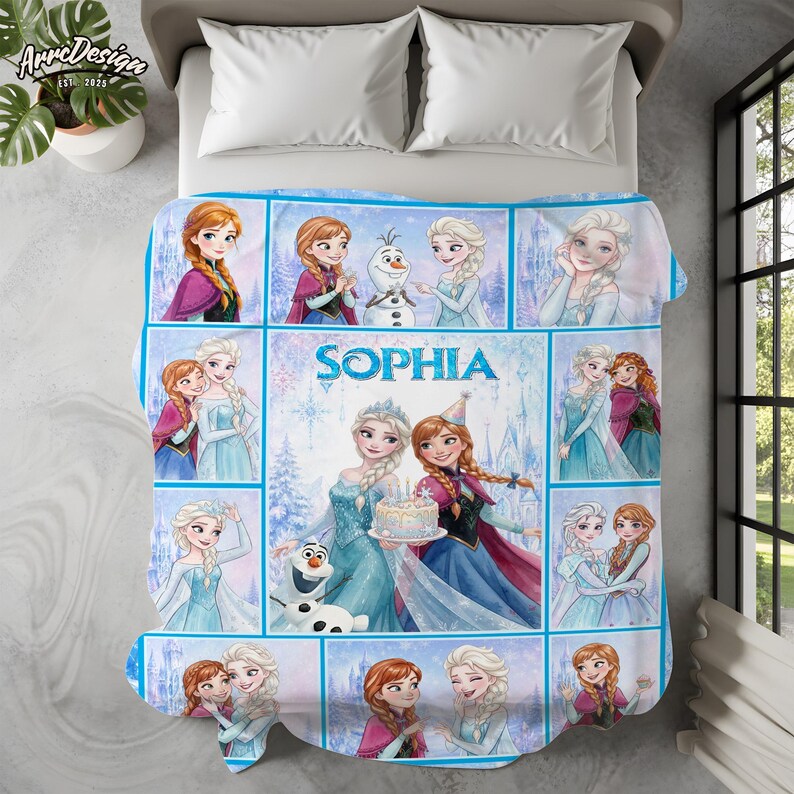 May include: A fleece blanket featuring a collage of Frozen characters including Anna, Elsa, and Olaf in various scenes. The center panel displays the name Sophia in blue text above an illustration of Elsa and Anna holding a birthday cake.