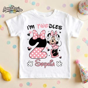 May include: White toddler t-shirt with a Minnie Mouse design. The shirt features the text "I'M TWOODLES" and the name "Sophia". The number "2" is designed with a black and pink polka dot pattern, and Minnie Mouse is also featured.