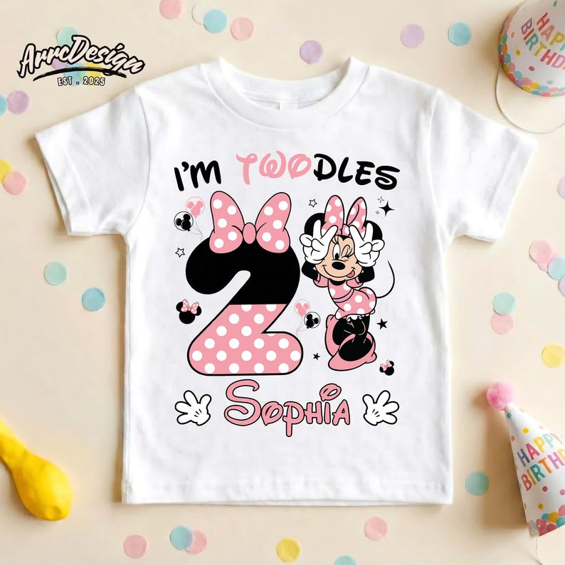 May include: White toddler t-shirt with a Minnie Mouse design. The shirt features the text "I'M TWOODLES" and the name "Sophia". The number "2" is designed with a black and pink polka dot pattern, and Minnie Mouse is also featured.