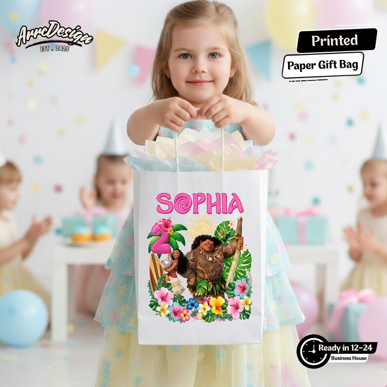 May include: A white paper gift bag with the name "SOPHIA" in pink, featuring a colorful illustration of characters and tropical flowers. The bag is held by a young girl at a birthday party.
