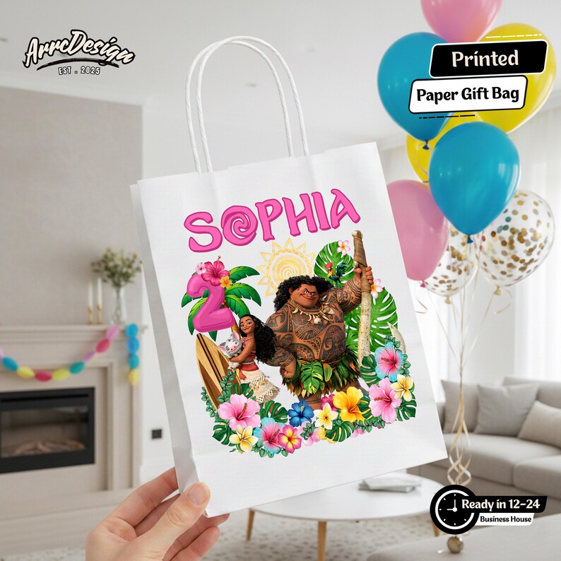 May include: White paper gift bag featuring a colorful illustration of characters from the movie Moana, with the name "SOPHIA" in pink. The bag is decorated with tropical flowers and a number "2" balloon. The text "Printed Paper Gift Bag" is also visible.