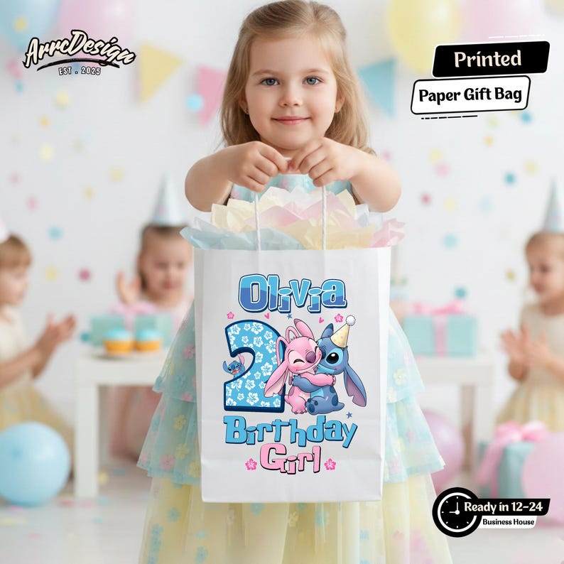 May include: A white paper gift bag featuring the name "Olivia", the number "2", and cartoon characters. The bag also has the text "Birthday Girl". The bag is held by a young girl at a birthday party.