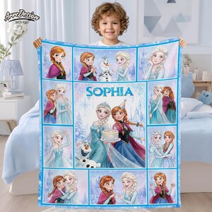 May include: A rectangular fleece blanket featuring a collage of Frozen characters including Elsa, Anna, and Olaf. The center panel displays the name Sophia in blue text above Elsa and Anna holding a cake. The design uses a light blue color palette.