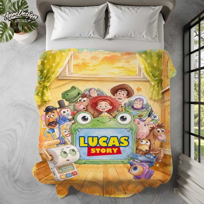 May include: A rectangular fleece blanket featuring a colorful illustration of various animated toy characters surrounding a central green frog-shaped frame. The text LUCAS STORY is printed in bold yellow and red letters inside the green frame.