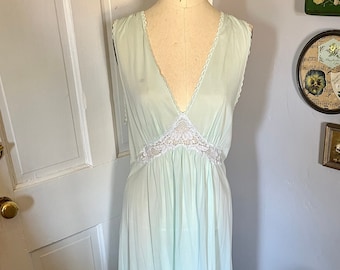 May include: A light blue sleeveless nightgown with a white lace trim around the neckline and waist.