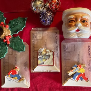 May include: Three vintage Christmas cards with a winter scene, a child sledding, and two children carrying a long board. The cards are on brown paper with a white border and the words "Merry Christmas" and "Vericolor" printed on them.