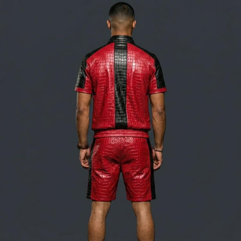 May include: A short-sleeved shirt and shorts set featuring a red and black crocodile skin texture pattern. The shirt has a central black vertical panel and black side panels, while the shorts feature matching black side panels along the legs.