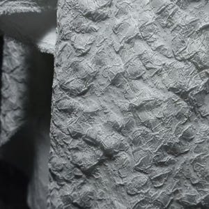May include: A white fabric with a highly textured, raised, and crinkled surface pattern. The material features a dense, three-dimensional embossed design that creates a complex interplay of light and shadow across the folded textile surface.