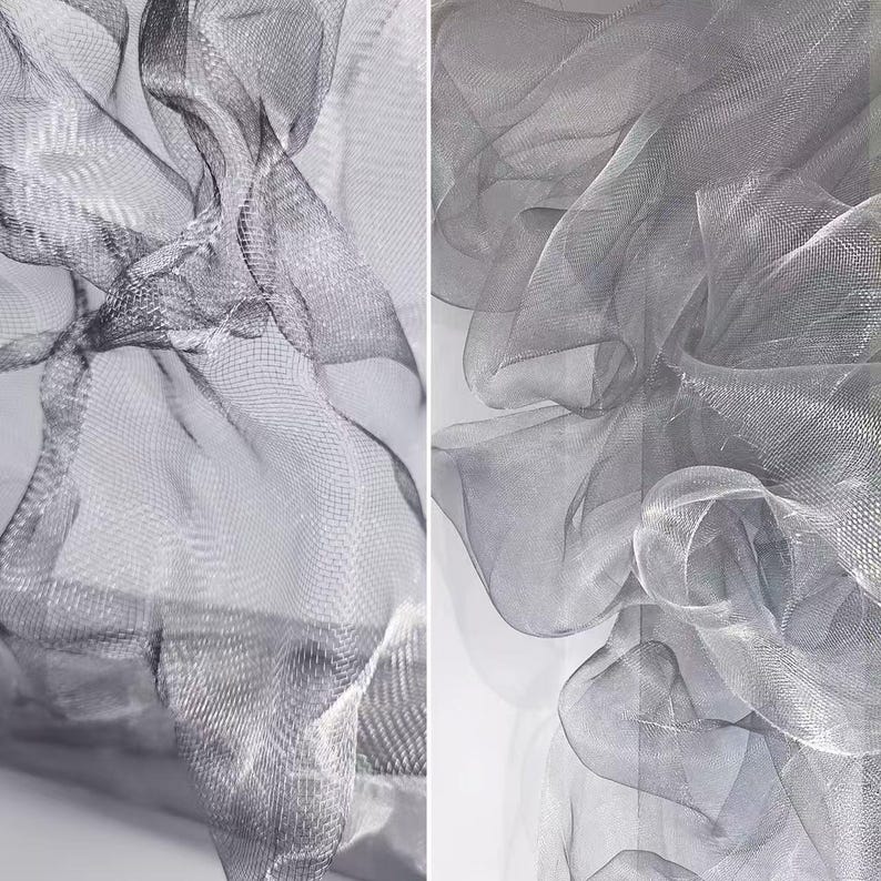 May include: Two-panel image featuring flowing, sheer fabric in shades of gray. The fabric is arranged in soft, undulating folds, creating a sense of movement and texture. The material appears to be a fine mesh or netting, with a subtle sheen.