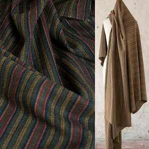 May include: Close-up and full shot of fabric with a striped pattern. The fabric features vertical stripes in olive green, gold, red, and navy blue. The fabric on the right is draped over a form, showing a brown striped pattern.