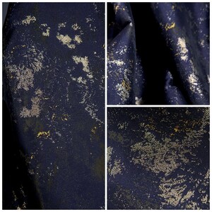 May include: A close-up of a dark blue fabric with a distressed metallic gold and silver pattern. The fabric has a textured appearance, with the metallic accents creating a mottled effect across the surface. The image is composed of three separate views of the fabric.