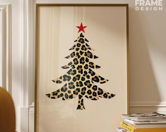 May include: A framed print featuring a Christmas tree design with a leopard print pattern. The tree is topped with a red star. The print is in a gold frame and is displayed against a neutral background. The text "FIKA FRAME DESIGN" is in the upper right corner.