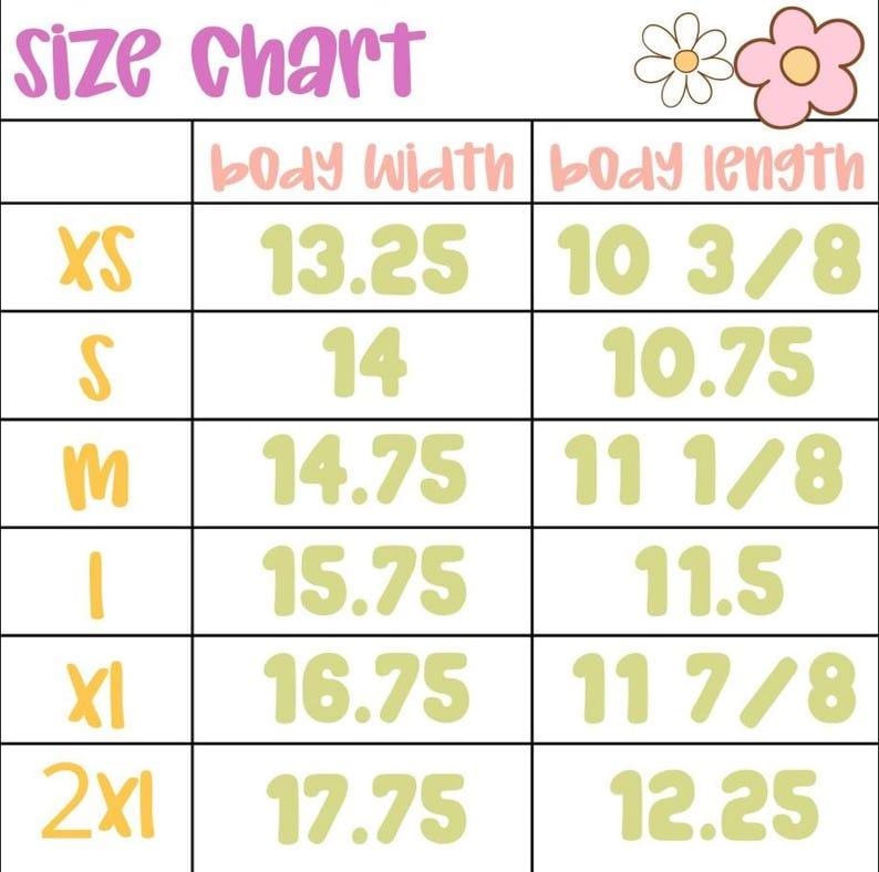 May include: A size chart with measurements in inches for body width and body length. The chart includes sizes XS to 2XL, with corresponding measurements such as 13.25 inches for XS body width and 10 3/8 inches for XS body length.