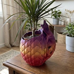 May include: A set of three ceramic mugs with a speckled, matte finish. The mugs are in shades of cream, light gray, and dark gray. Each mug has a simple, minimalist design, perfect for coffee or tea.