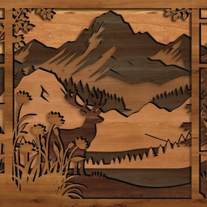 May include: Wooden wall art featuring a mountain landscape with a deer, trees, and flowers. The artwork is framed with a window-like design, showcasing a layered effect with varying shades of brown and tan.