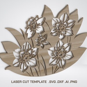 May include: A laser-cut wooden floral design featuring daffodils. The design includes five flowers with white petals and brown centers, set against a brown background. The text "LASER CUT TEMPLATE .SVG .DXF .AI .PNG" is at the bottom.