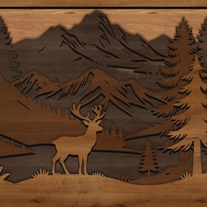 May include: Wooden wall art featuring a layered mountain scene with a deer silhouette. The artwork uses various shades of brown and tan to depict trees, mountains, and a deer in a natural landscape. The piece is framed.