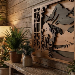 May include: A wooden wall art piece with a mountain scene, framed by a window-like design. The artwork is displayed above a rustic wooden shelf with potted plants. A fireplace with a burning fire is in the background.
