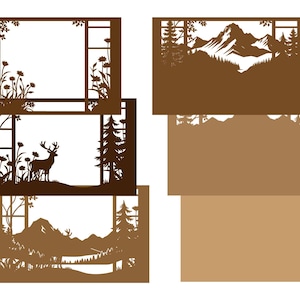 May include: A collection of brown paper cutouts featuring nature scenes. Designs include a deer in a forest, mountains, trees, and floral arrangements. The cutouts are rectangular and have intricate details.