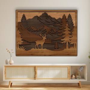 May include: A wooden wall art piece depicting a forest scene with a deer, mountains, and trees. The artwork is made of layered wood in shades of brown and tan, creating a 3D effect. The piece is rectangular and mounted on a light-colored wall.