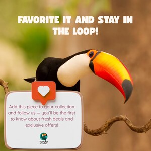 May include: A toucan with a large orange, yellow, and black beak sits behind a white sign with rounded corners. The sign features a red heart icon and text that reads: FAVORITE IT AND STAY IN THE LOOP! Add this piece to your collection and follow us.