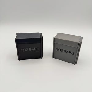 May include: Two rectangular boxes, one black and one grey, are shown against a white backdrop. The text "5OZ BARS" is printed on the front of each box. The boxes appear to be made of a solid material.