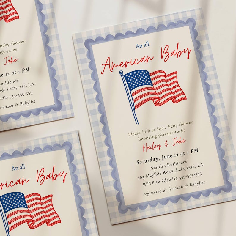 Three All American Baby shower invitations fanned out in a flat lay showing the full red white and blue design with American flag illustration, scallop border detail