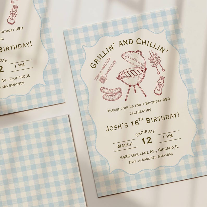 Three BBQ birthday party invitations arranged on a white surface showing a cream card with a blue gingham plaid background and a decorative scalloped cream frame in the center, featuring detailed hand-drawn etching-style illustrations of a kettle barbecue grill, grilling spatula and fork tools, sausages, meat skewers and a BBQ sauce bottle arranged around the grill in dark red, with arched "Grillin' and Chillin'" heading in dark olive green