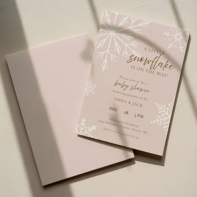 A little snowflake is on the way, girl baby shower template featuring white snowflakes on a dusty pink background with editable text