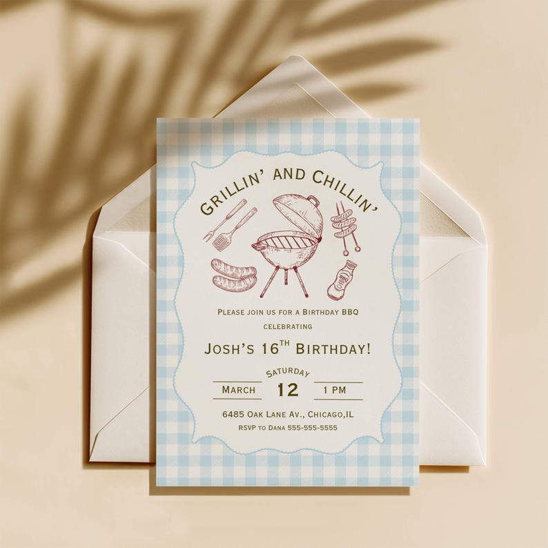 BBQ birthday party invitation  showing the full blue gingham background card with decorative scalloped cream inner frame, detailed hand-drawn dark red etching-style BBQ illustrations including a kettle grill, grilling tools, sausages, skewers and BBQ sauce bottle, arched dark olive "Grillin' and Chillin'" heading
