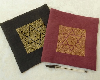 May include: Two fabric pouches with a gold Star of David design. One pouch is black and the other is burgundy.