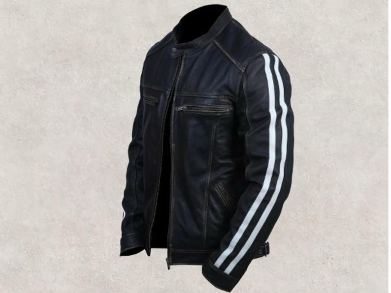 May include: Black leather jacket with white stripes on the sleeves. The jacket has a classic biker style with a zip-up front, a small collar, and a distressed finish. The jacket has a fitted silhouette.