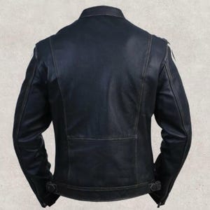 May include: A black leather jacket with a classic design. The back view shows a tailored fit, with a small rectangular panel at the lower back and adjustable buckles at the waist. The jacket has a stand-up collar and shoulder detailing.