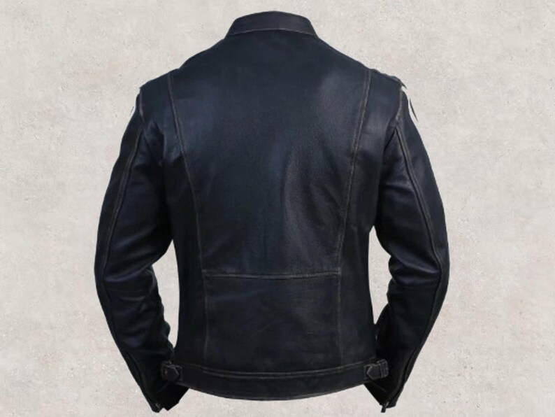 May include: A black leather jacket with a classic design. The back view shows a tailored fit, with a small rectangular panel at the lower back and adjustable buckles at the waist. The jacket has a stand-up collar and shoulder detailing.