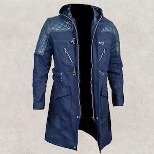 Könnte beinhalten: Ein langer, marineblauer Mantel mit gesteppten Schultern und mehreren silbernen Reißverschlüssen. Der Mantel hat eine Kapuze und mehrere Taschen. Der Mantel ist dunkelblau.