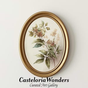 May include: An oval-shaped framed botanical print. The artwork features a watercolor illustration of a flowering branch with green leaves and delicate blossoms in shades of beige and brown. The frame is gold-colored, and the text "Casteloria Wonders Curated Art Gallery" is at the bottom.