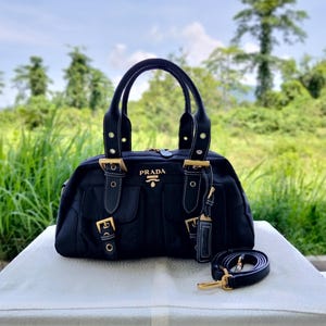 Bolso Prada tipo bowling de nailon negro con múltiples bolsillos - Bolso estilo Y2K con correa cruzada.