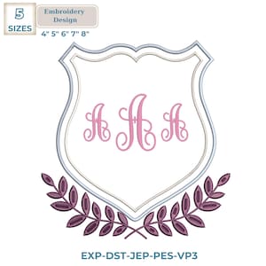 May include: An embroidery design featuring a shield shape with three pink letter "A" monograms. The shield is outlined in silver and white, with a decorative purple leaf design at the bottom. The design is available in 5 sizes, from 4" to 8".