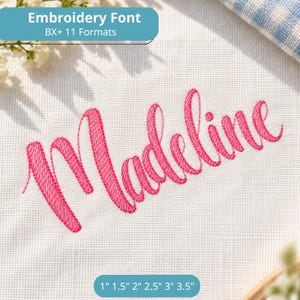 May include: An embroidery font design featuring the name Madeline stitched in bright pink thread on white fabric. The text includes the label Embroidery Font BX+ 11 Formats and size options listed as 1 inch, 1.5 inches, 2 inches, 2.5 inches, 3 inches, and 3.5 inches.