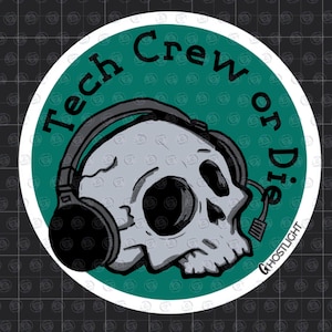 May include: A round sticker with a teal green background and a white border. The sticker features a gray skull wearing headphones. The words "Tech Crew or Die" are written around the skull. The word "GHOSTLIGHT" is written at the bottom.