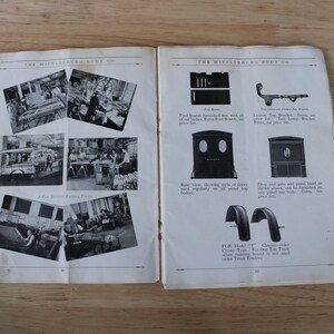 May include: An open book with black and white images and text. The left page features photographs of a workshop and vehicles. The right page displays illustrations of vehicle parts, including fenders and brackets. The text reads "THE WIFFLEBURG BODY CO."