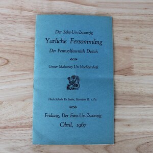 May include: A blue pamphlet with black text. The text includes "Der Seks-Un-Zwonzig", "Yarliche Fersommling", and "Fridaag, Der Eins-Un-Zwonzig". The pamphlet also features a small illustration and the date "Obril, 1967".
