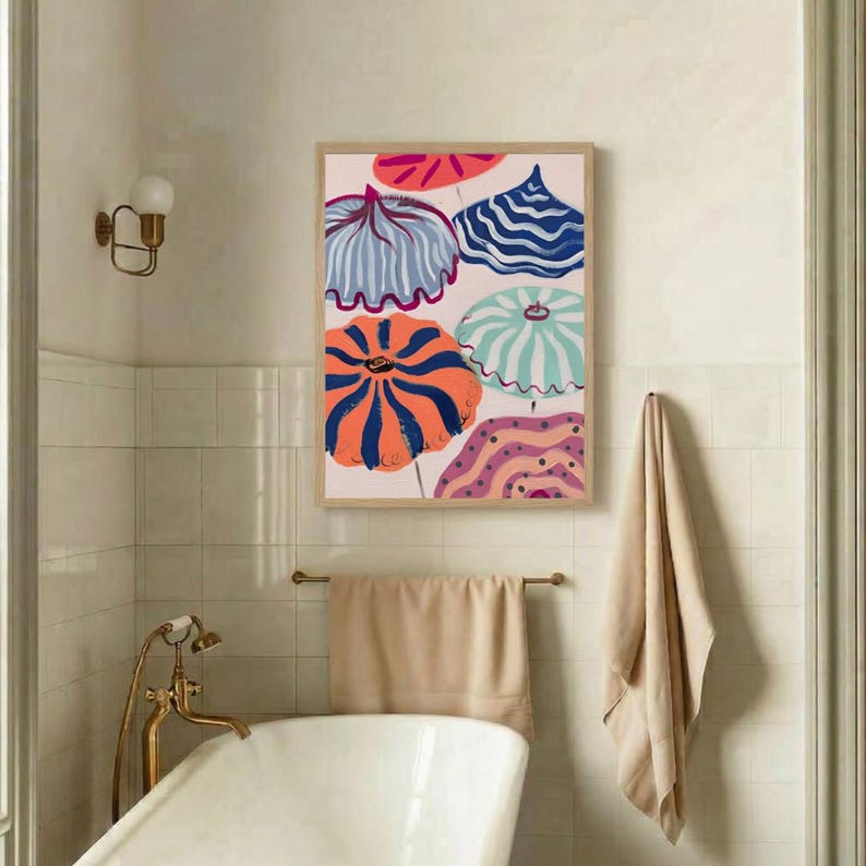 May include: A framed art print featuring colorful, stylized beach umbrellas in shades of blue, orange, pink, and purple. The artwork is displayed in a bathroom setting, with a neutral color palette and a vintage-style bathtub.