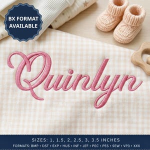 May include: A beige and white gingham fabric featuring the embroidered name Quinlyn in pink cursive script. Included are a pair of light peach knit booties and a wooden teether. Text reads BX FORMAT AVAILABLE and SIZES 1, 1.5, 2, 2.5, 3, 3.5 INCHES.