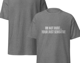 May include: Two grey t-shirts. The front t-shirt has the text "IM NOT RUDE... YOUR JUST SENSITIVE" in white. The shirts are short-sleeved and have a crew neck.