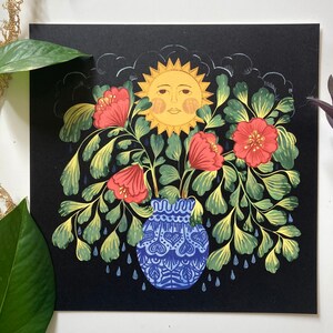 May include: A blue and white ceramic vase with a floral design is filled with red flowers and green leaves. A yellow sun with a face is above the vase, and blue raindrops fall from the sky.